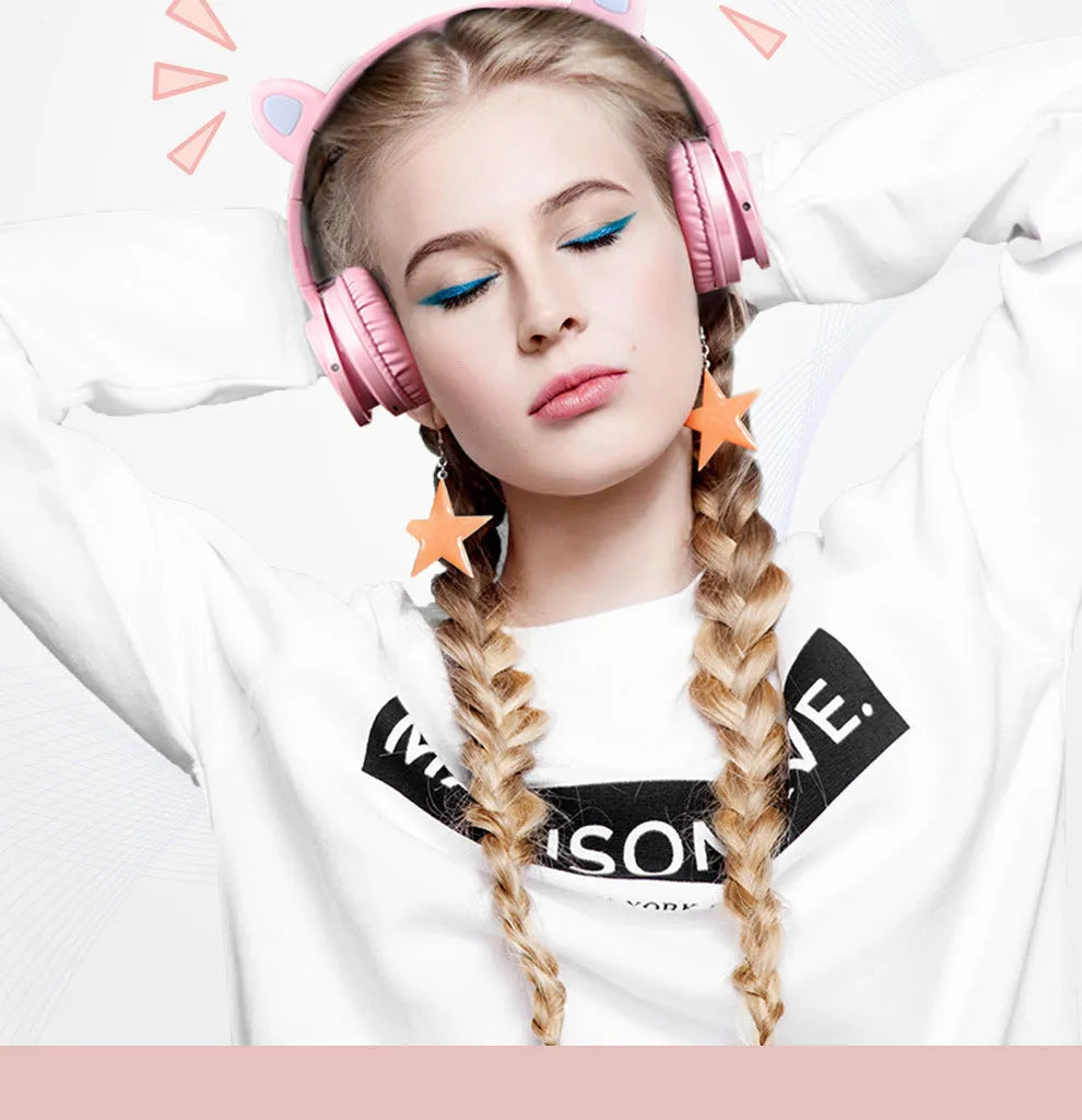 Pink and white wireless Bluetooth headphones with head-mounted design and braided cable