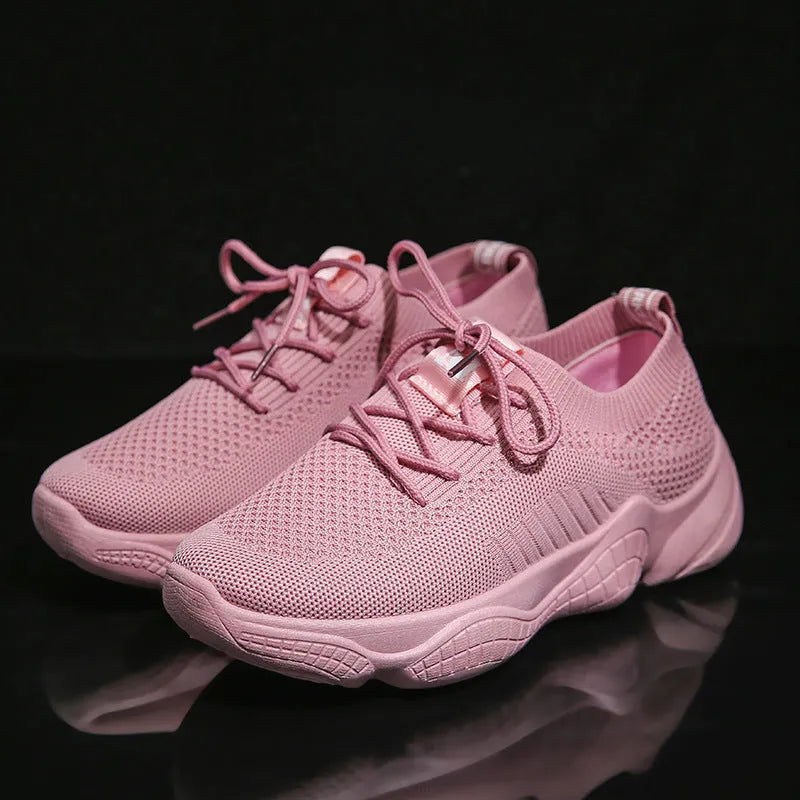 Women's white thick-soled sports shoes with flying woven upper and front strap.