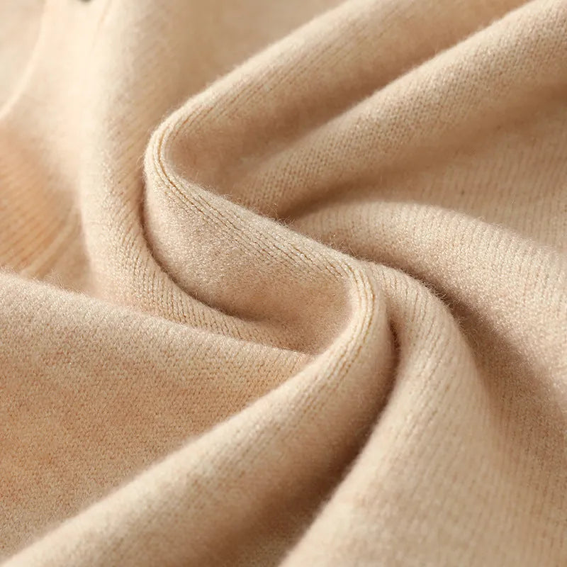 Man wearing a loose beige Andy Velvet V-neck cardigan coat with long sleeves.