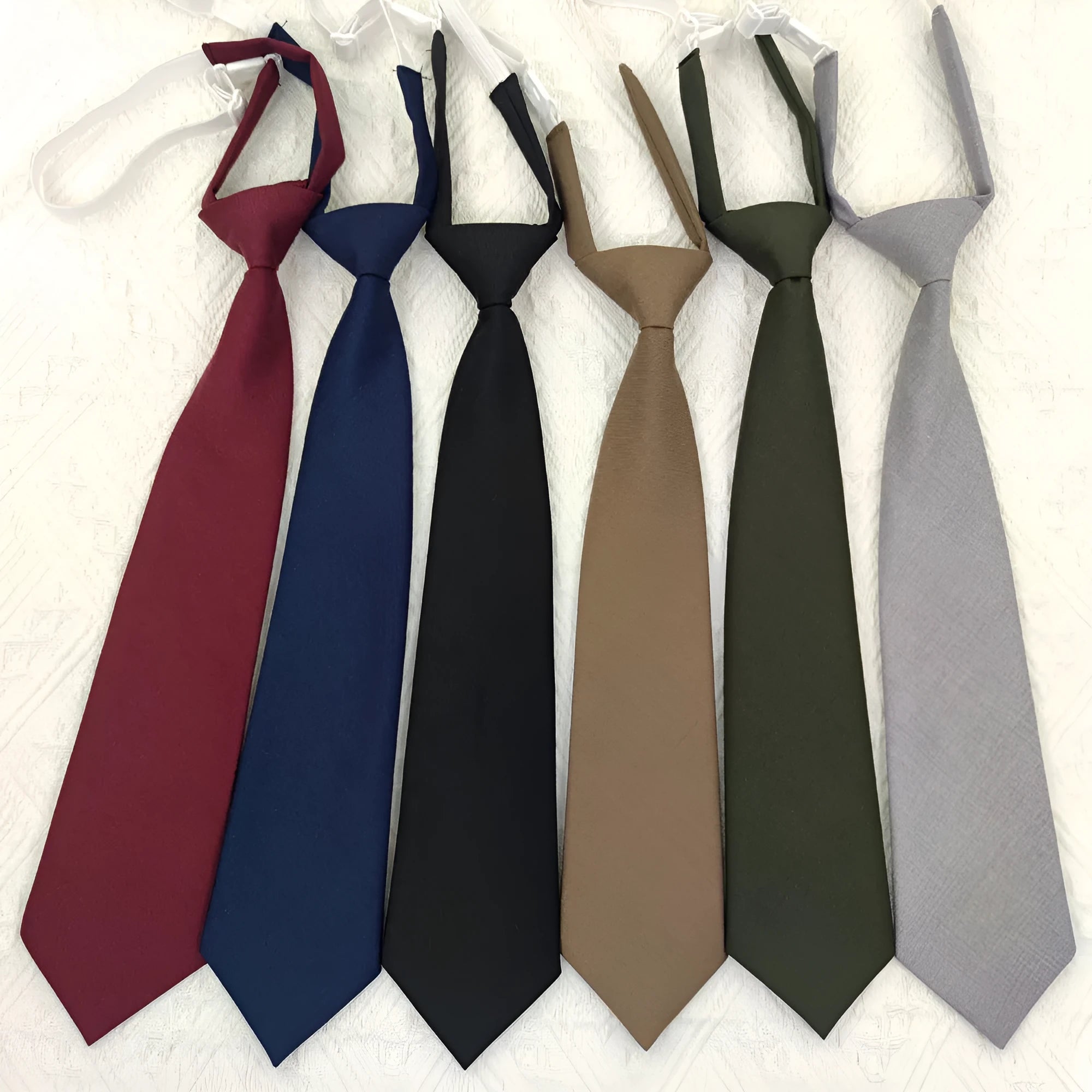 Men's solid colour cotton bow tie in arrow style, shown in navy blue.