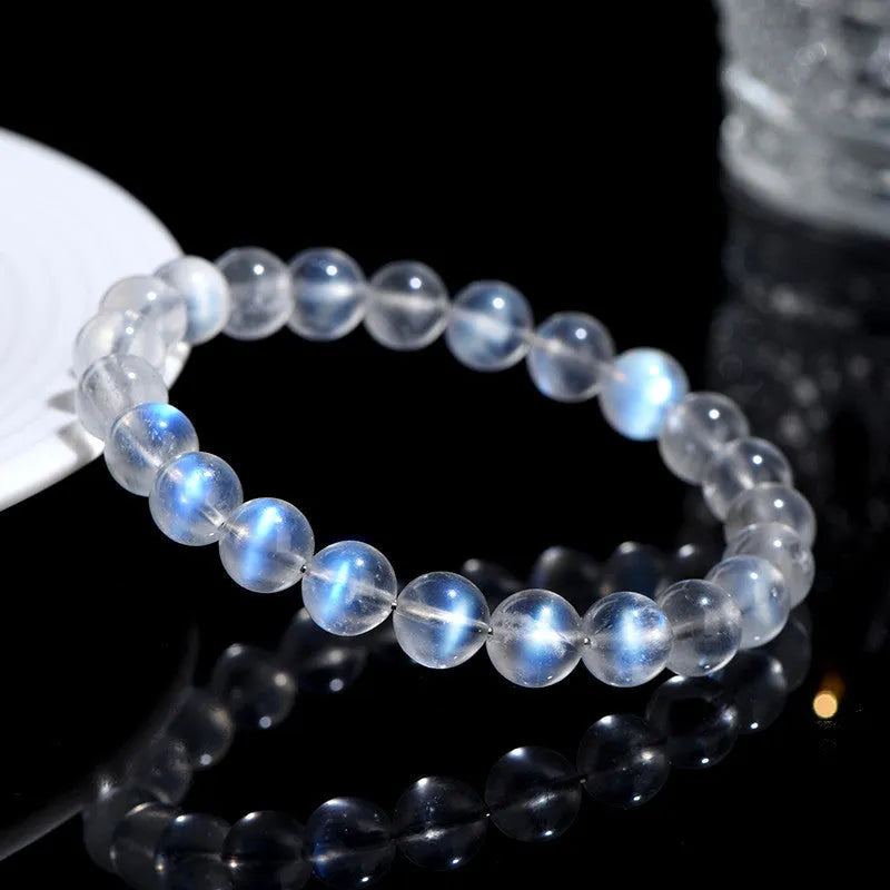 Natural cream body blue moonlight crystal bracelet on a wrist, showing single circle format.