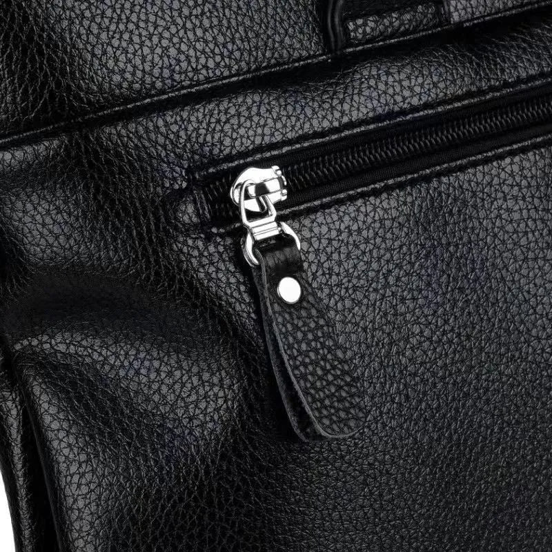 Men's black PU leather business messenger bag with shoulder strap showing spliced panel design.