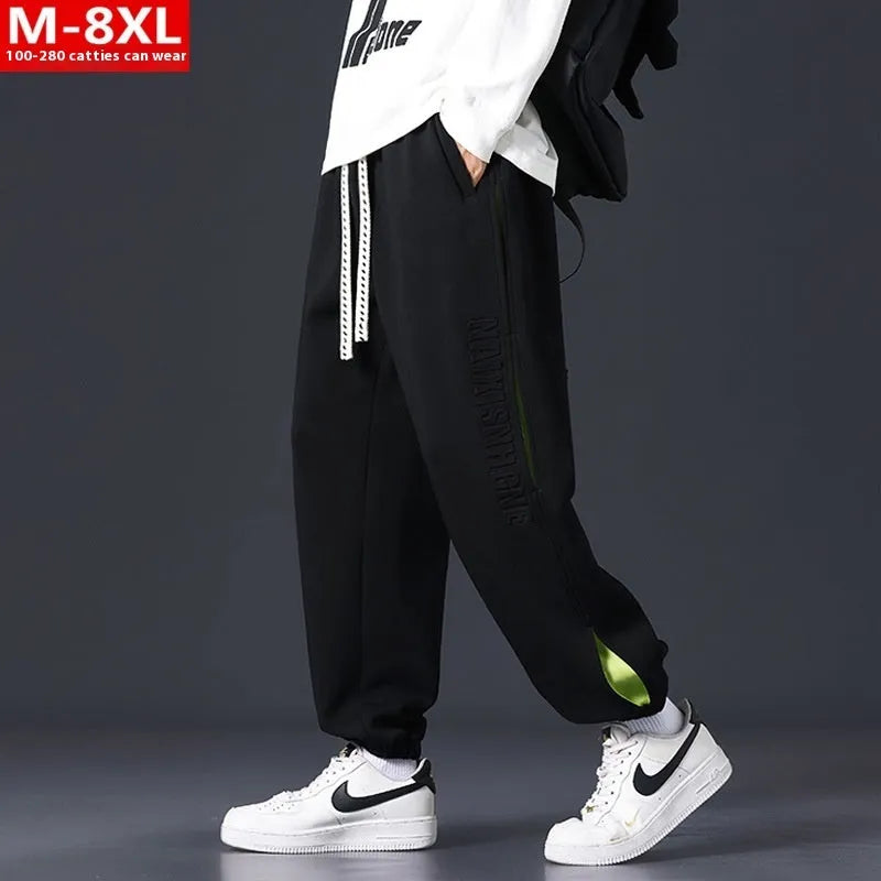 Men's grey green cotton casual trousers with white collage stitching detail and an elasticated ankle band.