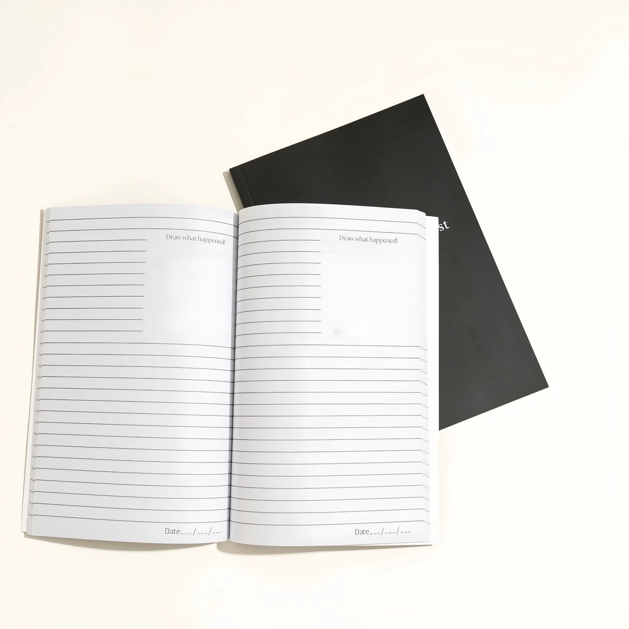 Black hardcover A5 dream journal notebook with lined pages showing business simplicity style