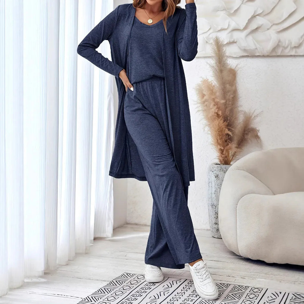 Blue women's three-piece trouser suit set with long cardigan on a hanger.
