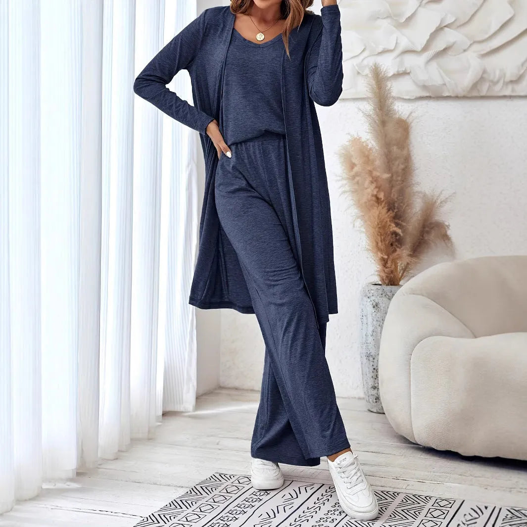 Blue women's three-piece trouser suit set with long cardigan on a hanger.