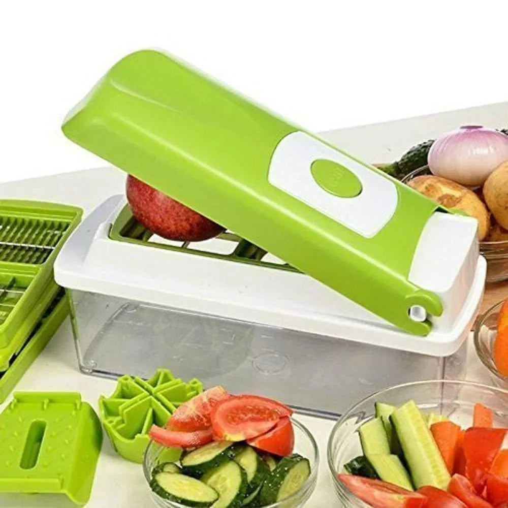 Green manual food chopper with stainless steel blades and plastic body on a kitchen worktop.