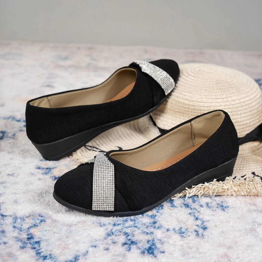 Black women's slip-on casual shoes with rhinestones on the toe and a chunky heel.