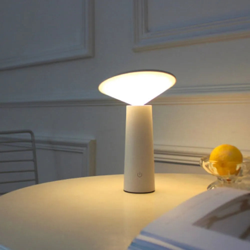 Black USB LED desk lamp with touch sensor base and an angled lamp head on a wooden desk.