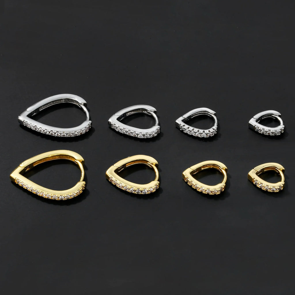 A geometric heart-shaped copper ear clip with a gold or white electroplated finish.