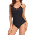 A black one-piece swimsuit with mesh panelling and a backless design on a mannequin.