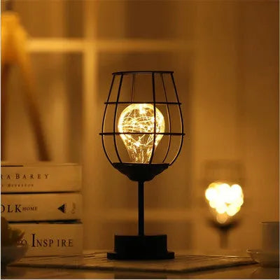 Minimalist hollow iron table lamp in wine bottle design with warm white LED lighting