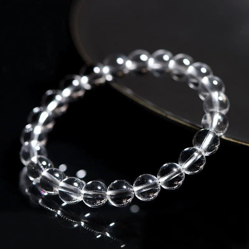 Natural Donghai Old Mine white crystal round bead bracelet on a wrist, showing geometric single strand design.