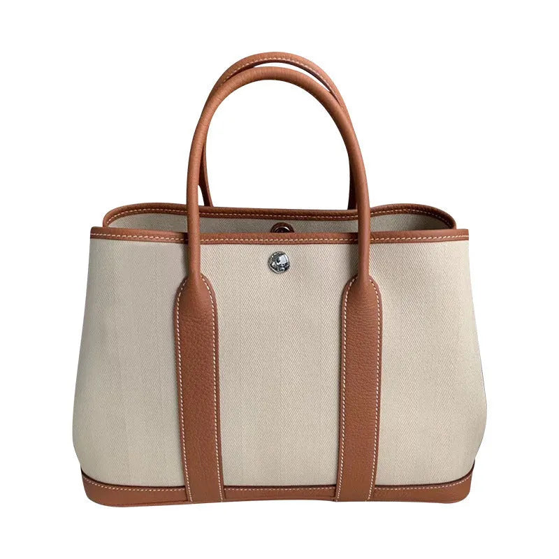 Women's canvas bucket tote bag with genuine leather details in black colour option