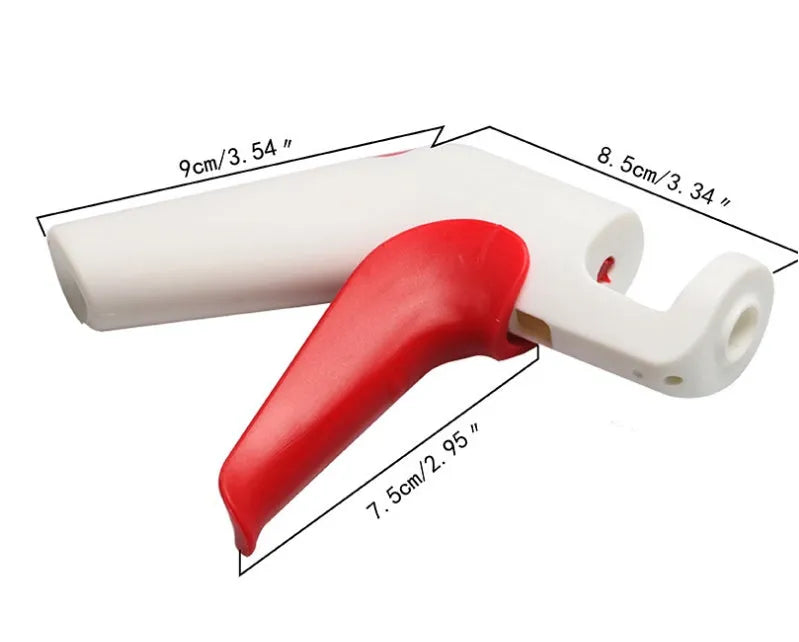 Stainless steel cherry kernel remover pitter tool on a kitchen worktop