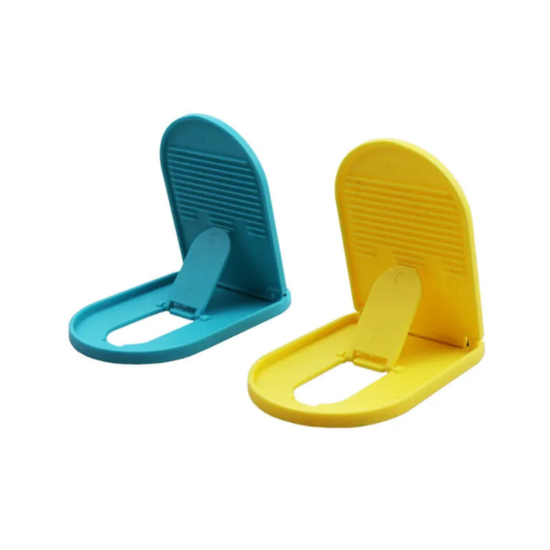 A plastic lazy bracket phone stand holding a mobile smartphone on a table.