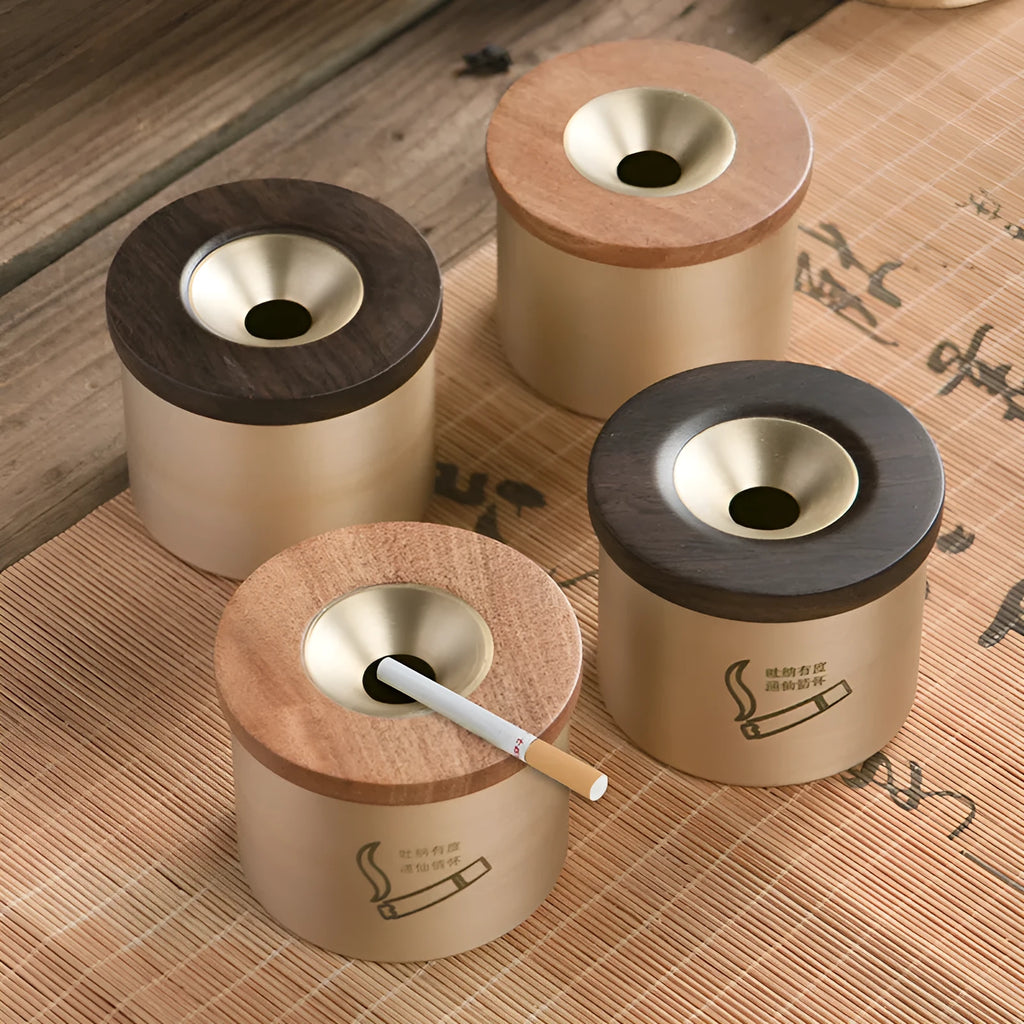Brass ashtray with wooden lid showing centre hole design and copper construction