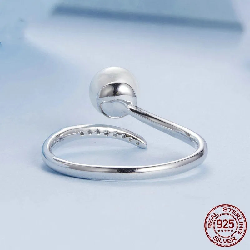 Shell pearls ring with S925 sterling silver construction and adjustable open loop design featuring natural pearl accent