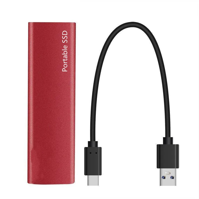 Ultra-thin metal portable external SSD drive in red, shown next to a laptop.
