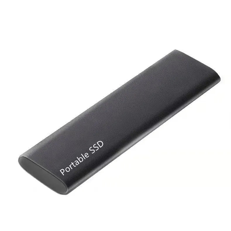 Ultra-thin metal portable external SSD drive in red, shown next to a laptop.