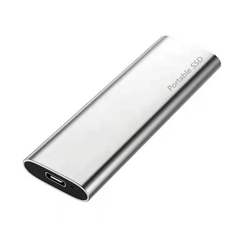 Ultra-thin metal portable external SSD drive in red, shown next to a laptop.