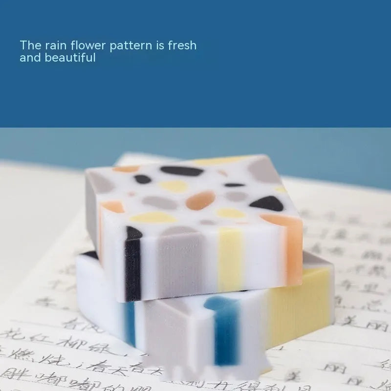 A single brick-shaped white rubber eraser for removing pencil marks.