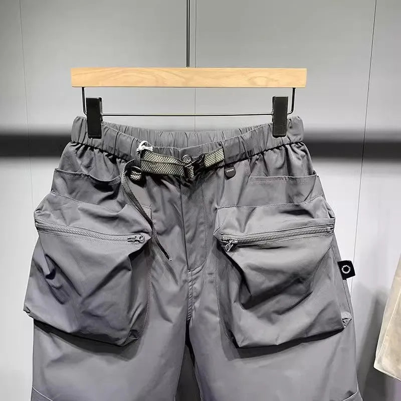 Men's loose fit black casual shorts with large side pockets and an elasticated waistband.