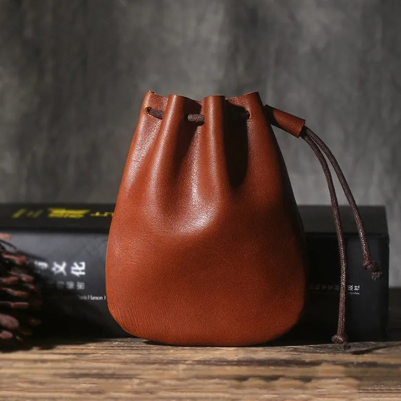 Vintage brown genuine cowhide leather drawstring bundle wallet with drawcord closed.