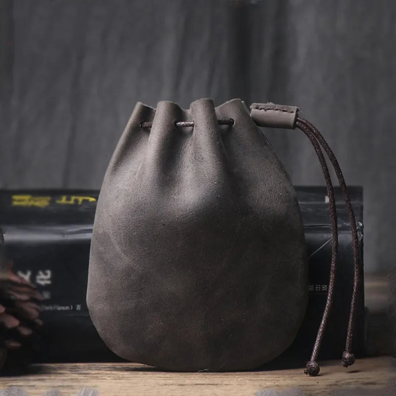 Vintage brown genuine cowhide leather drawstring bundle wallet with drawcord closed.