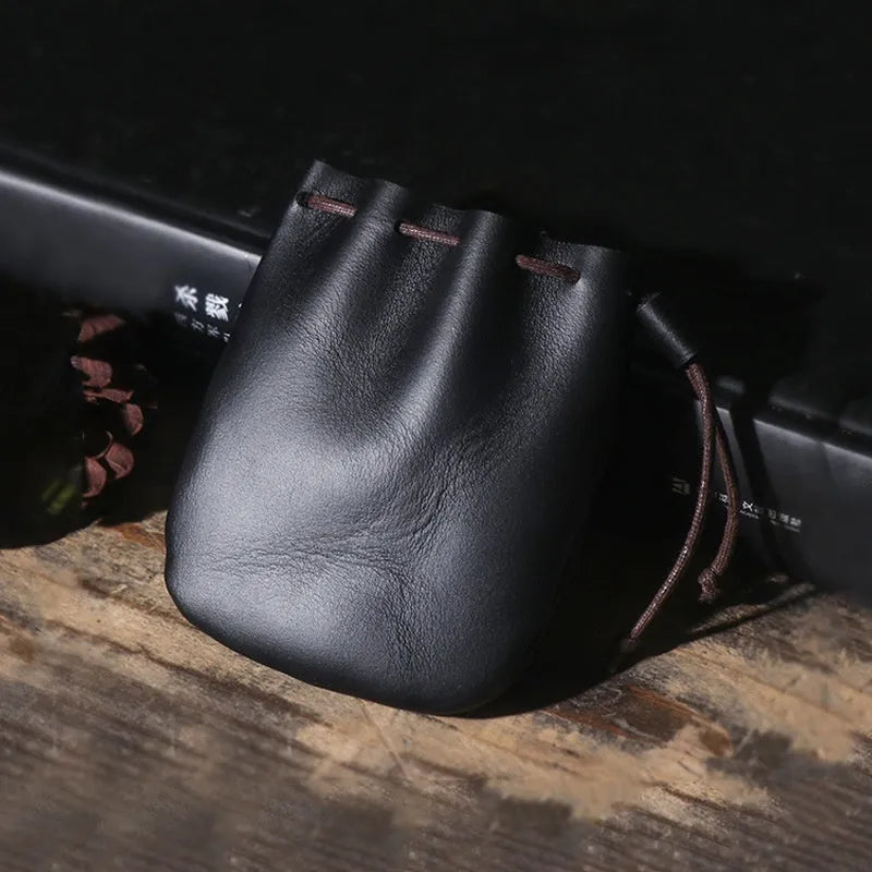 Vintage brown genuine cowhide leather drawstring bundle wallet with drawcord closed.
