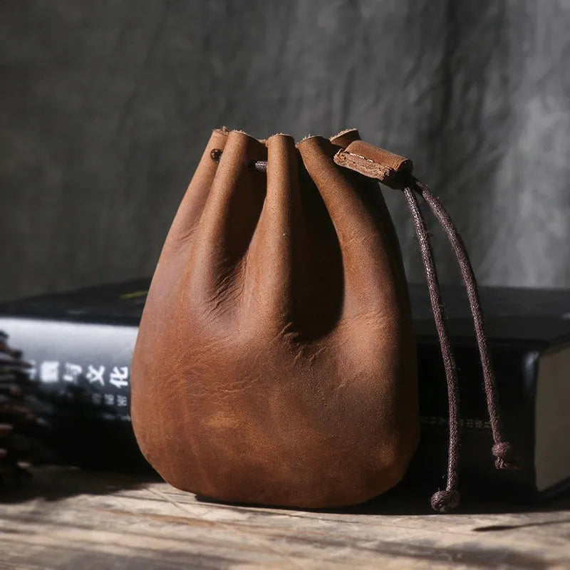 Vintage brown genuine cowhide leather drawstring bundle wallet with drawcord closed.