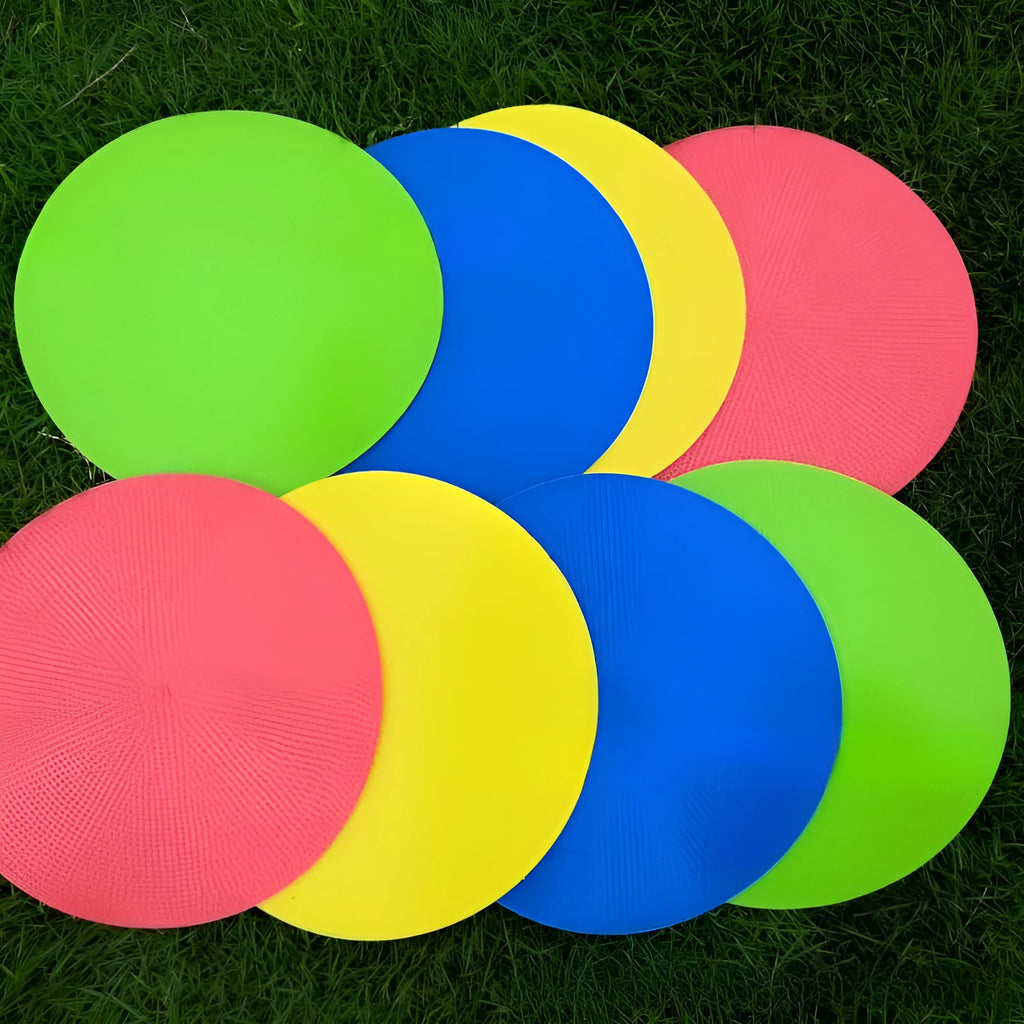 Soft TPE football training marker disc in yellow, 23 cm diameter, lying flat on grass.