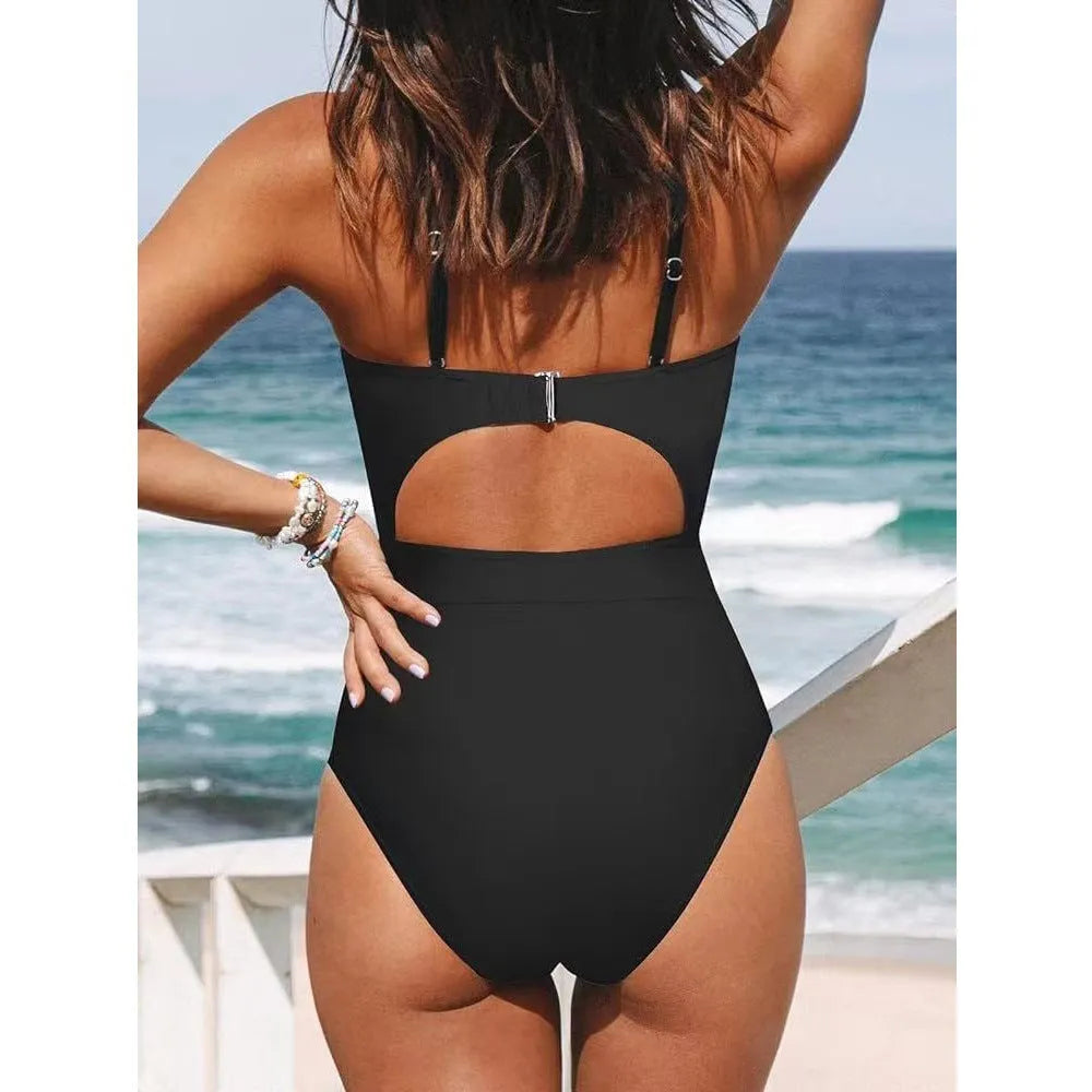 Solid colour women's one-piece swimsuit with a cross-back backless design, shown in black.
