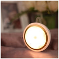 Smart battery-powered motion sensor LED light with infrared sensing on a white background.