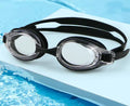 Prescription swimming goggles with corrective lenses in a protective case, shown in black colour.