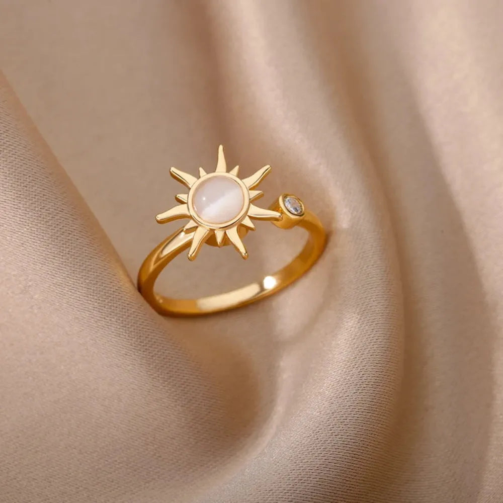 Geometric open mouth decompression ring with rotating band in gold electroplated finish