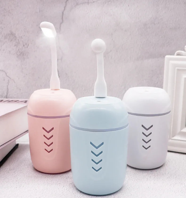 Portable car humidifier with columnar design in blue colour showing mist outlet and control dial