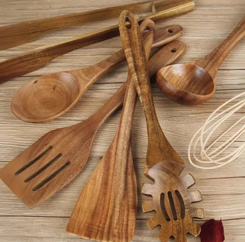 Seven wooden cooking utensils including spoons and shovels with non-slip handles