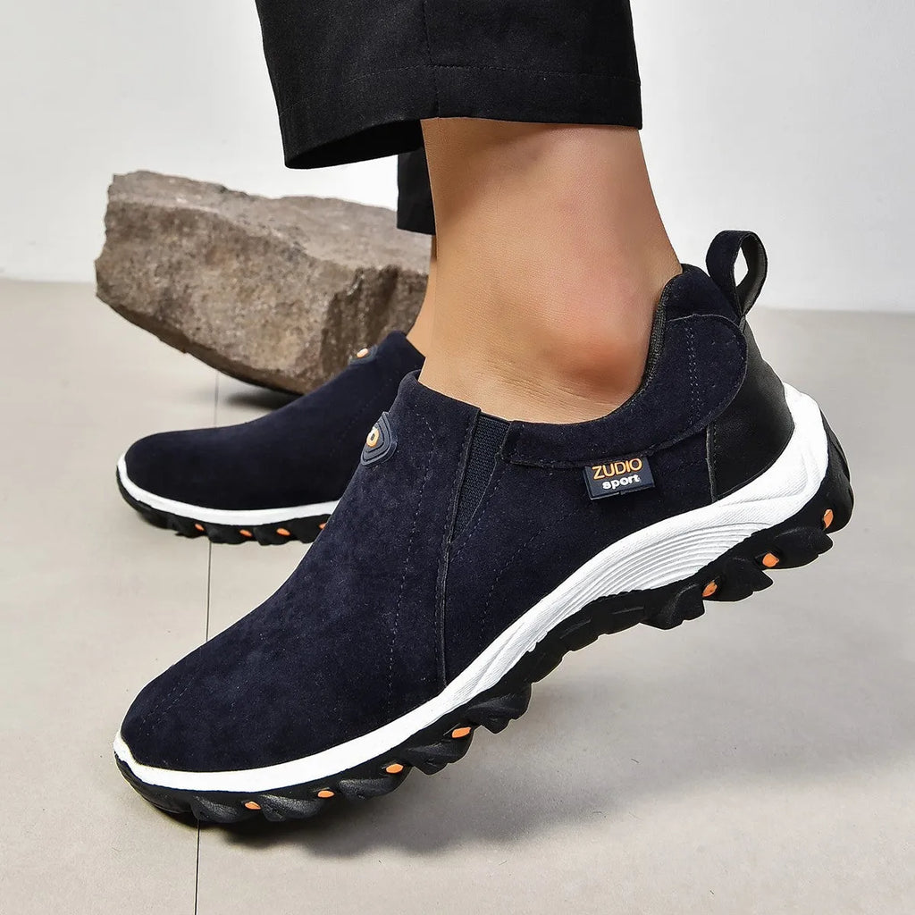 Men's grey slip-on shoes with round toe and shallow opening on rubber sole