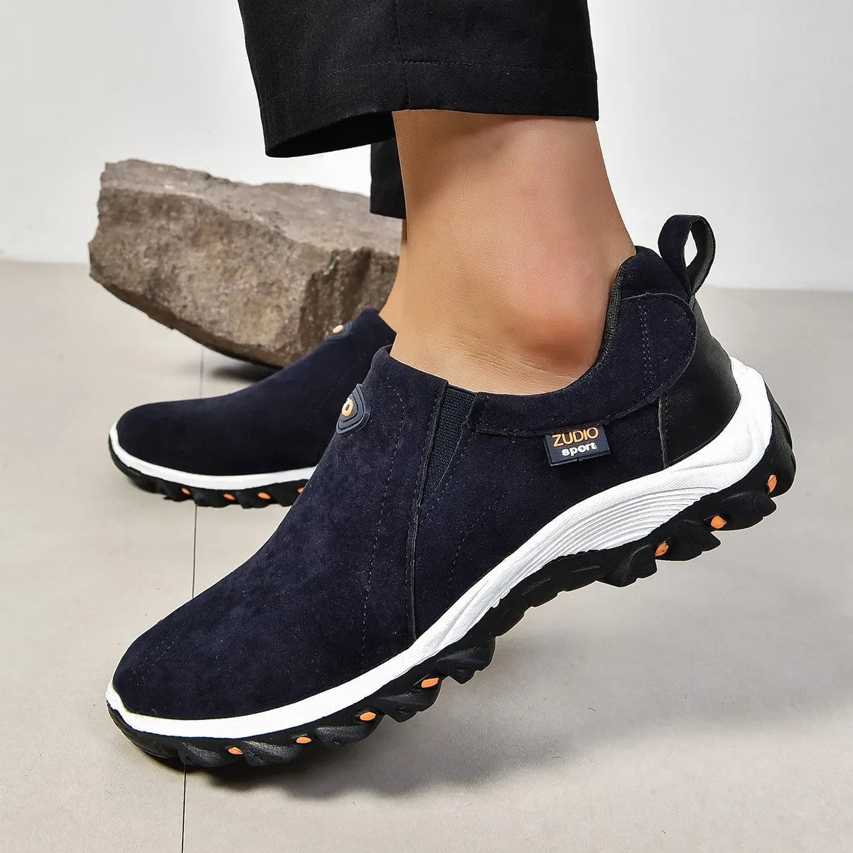 Men's grey slip-on shoes with round toe and shallow opening on rubber sole