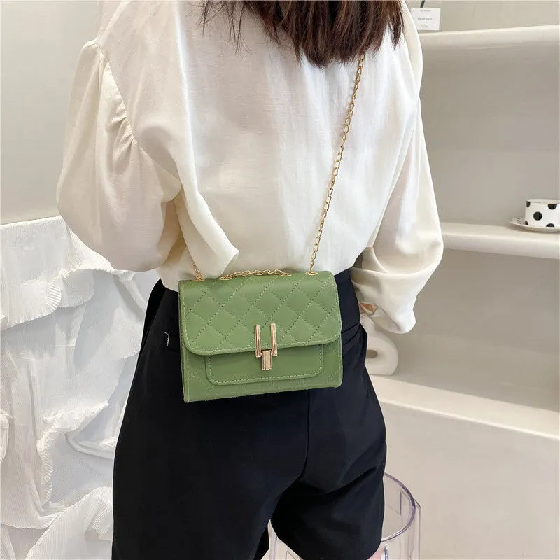 Women's minimalist crossbody bag with diamond lattice chain design in PU leather, showing adjustable strap and solid colour options