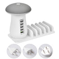 White mushroom-shaped LED desk lamp with a 5-port USB charging station at its base on a wooden table.