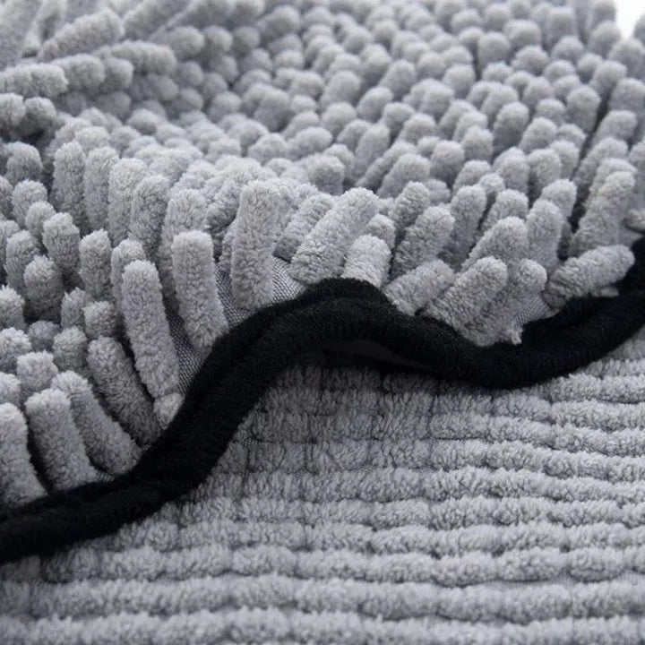 Blue pet bath robe towel wrapped around a small dog, showing its size and absorbent fabric.