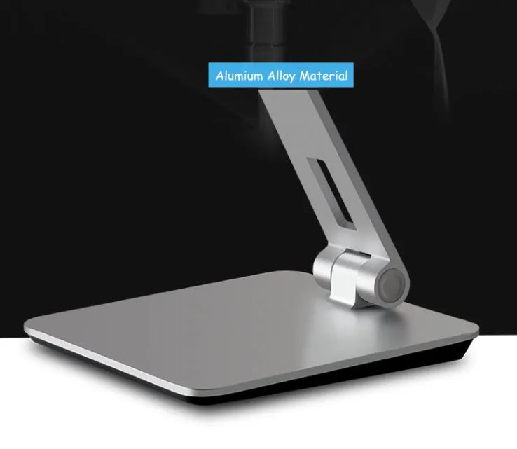 Black foldable aluminium phone and tablet stand with 360-degree rotation on a wooden desk