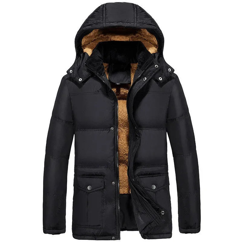 Man wearing a black loose-fit velvet padded jacket with a hood and double-breasted front.