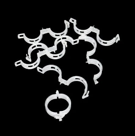 Set of 50 green plastic plant grafting clips for securing tomato vines and garden plants.