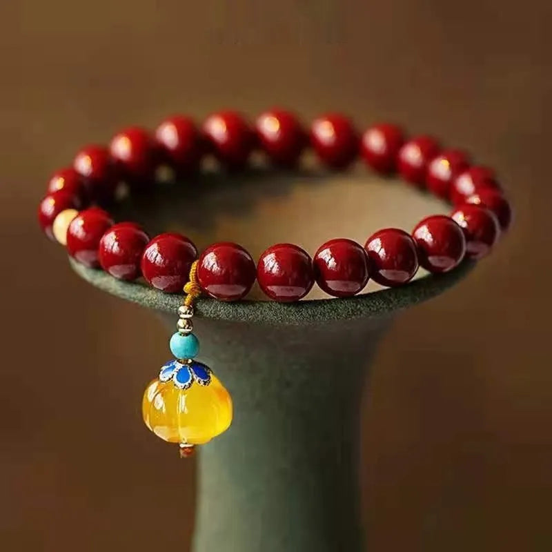 Handcrafted cinnabar bracelet with wave pattern design and copper bead accents in traditional Chinese style