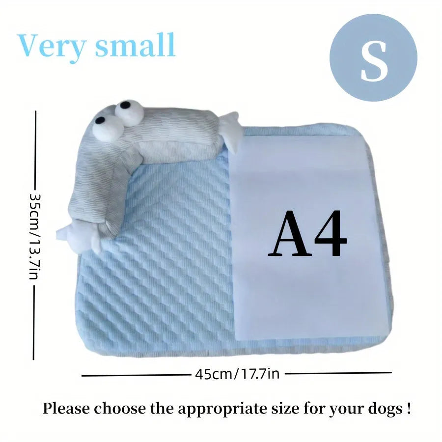Blue pet cooling mat with big-eyed monster print on a wooden floor