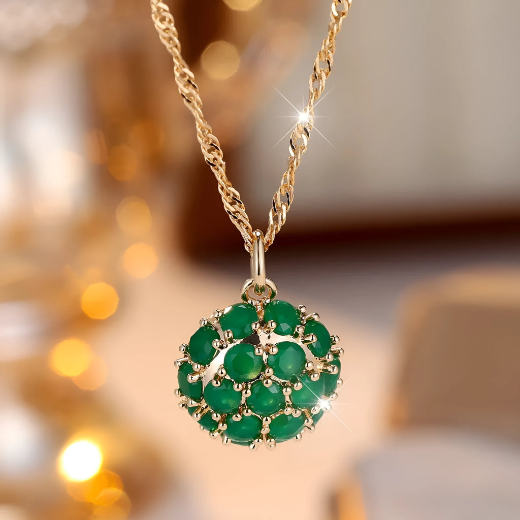 Round emerald and diamond pendant on an adjustable champagne gold electroplated copper chain necklace.