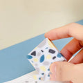 A single brick-shaped white rubber eraser for removing pencil marks.